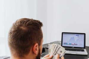 Entrepreneur using AI tools and digital platforms to make money online and build a self-employed business in 2026.